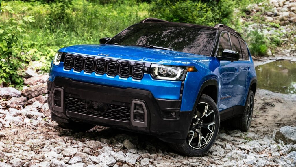 2025 Jeep Cherokee parked on a rugged trail with mountains in the background