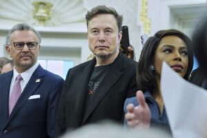 Elon Musk speaking at a press conference during his time in the Trump administration